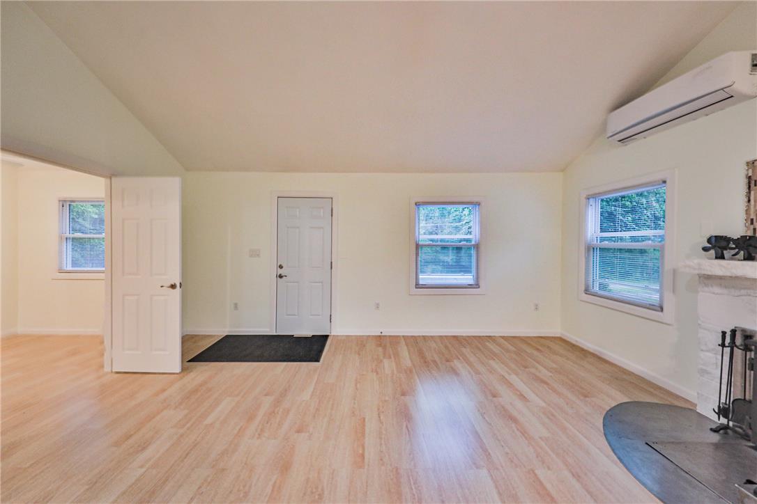 5599 Minks Pond Road Bushkill, PA 18324 - Photo 3 of 64 Laminated wood floors and high vaulted ceilings create an inviting living space.