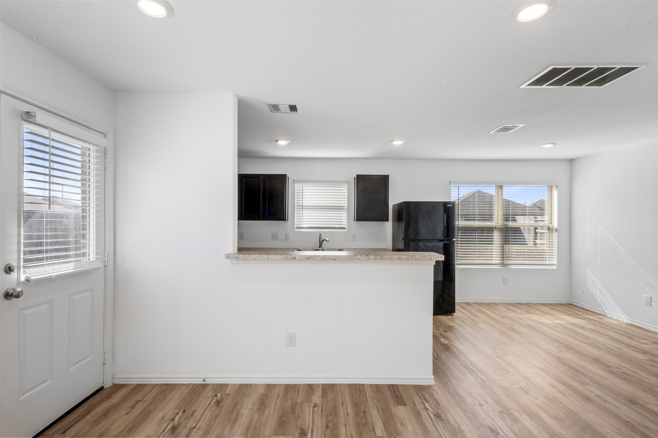 14538 Broadbury Pond Road Rosharon, TX 77583 - Photo 8 of 25 a view of kitchen with wooden floor and window