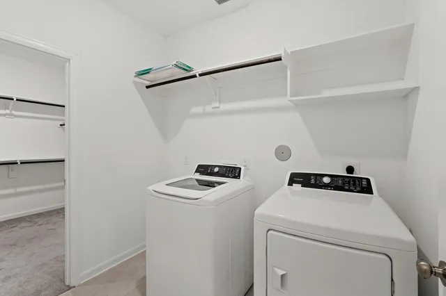 a view of storage and utility room with washer and dryer