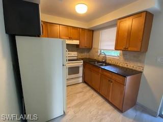 27677 Okeana Street, Unit 6 Bonita Springs, FL 34134 - Photo 12 of 31 a kitchen with stainless steel appliances a refrigerator sink and cabinets