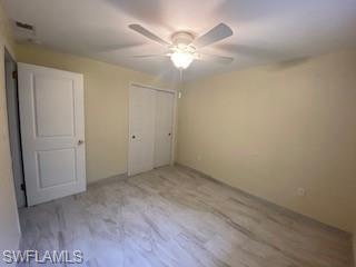 27677 Okeana Street, Unit 6 Bonita Springs, FL 34134 - Photo 14 of 31 an empty room with a chandelier fan and wooden floor