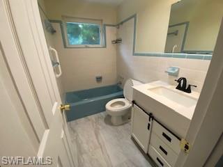 27677 Okeana Street, Unit 6 Bonita Springs, FL 34134 - Photo 15 of 31 a bathroom with a sink a toilet a mirror a vanity and shower