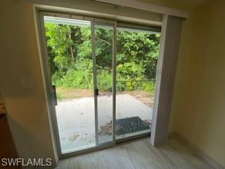 27677 Okeana Street, Unit 6 Bonita Springs, FL 34134 - Photo 22 of 31 a view of a glass door with a yard from a window