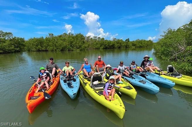 27677 Okeana Street, Unit 6 Bonita Springs, FL 34134 - Photo 26 of 31 swimming pool with boats and trees in the background