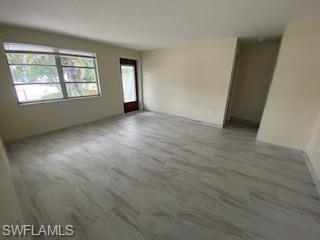 27677 Okeana Street, Unit 6 Bonita Springs, FL 34134 - Photo 7 of 31 an empty room with windows
