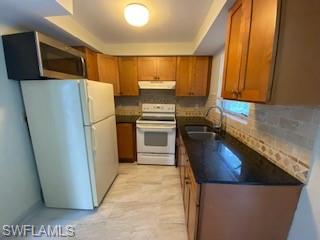 27677 Okeana Street, Unit 6 Bonita Springs, FL 34134 - Photo 9 of 31 a kitchen with a refrigerator and a sink