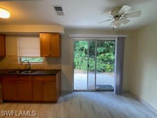 27677 Okeana Street, Unit 6 Bonita Springs, FL 34134 - Photo 10 of 31 a kitchen with granite countertop a sink and a cabinets