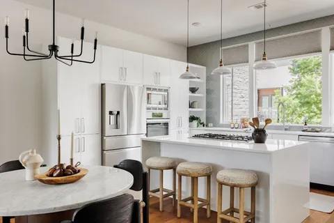a kitchen with stainless steel appliances granite countertop a sink and a refrigerator