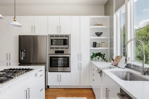 a kitchen with a sink stove and refrigerator
