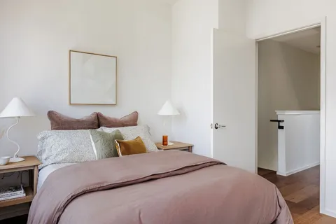 a bedroom with a bed and a night stand