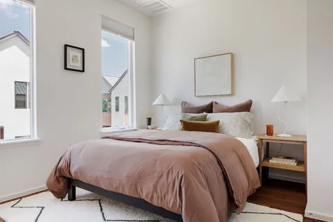 a bedroom with a bed and a painting on the wall