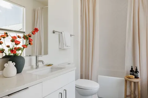 a bathroom with a sink toilet and shower