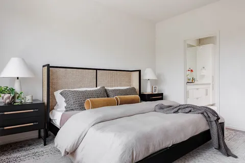 a bedroom with a bed and lamp