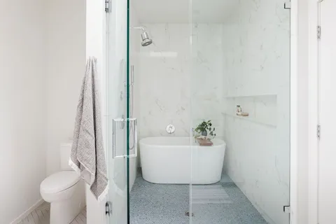 a bathroom with a sink toilet and shower