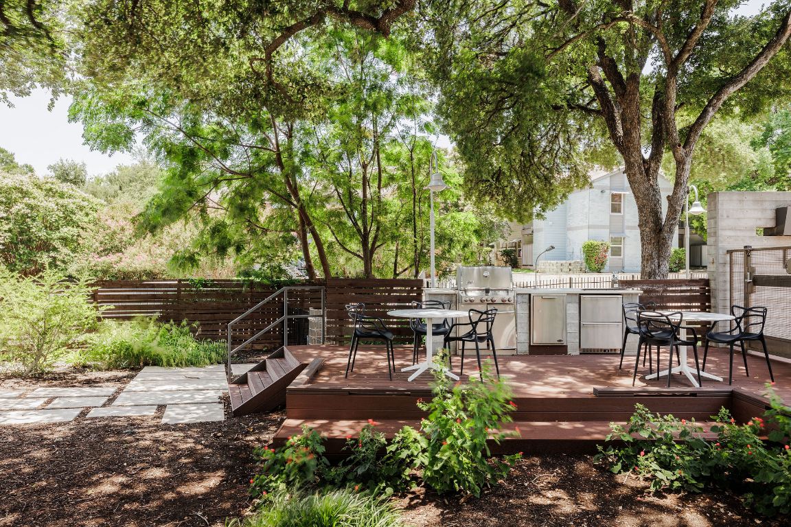 3100 Menchaca Road, Unit 6 Austin, TX 78704 - Photo 28 of 30 a view of a patio with table and chairs and a large tree