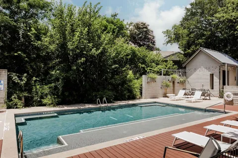 a view of a house with swimming pool and sitting area