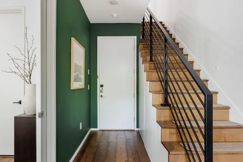 a view of a hallway with wooden floor and entryway