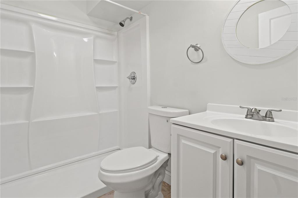 6515 Dimarco Road Tampa, FL 33634 - Photo 33 of 66 a bathroom with a sink a toilet and shower