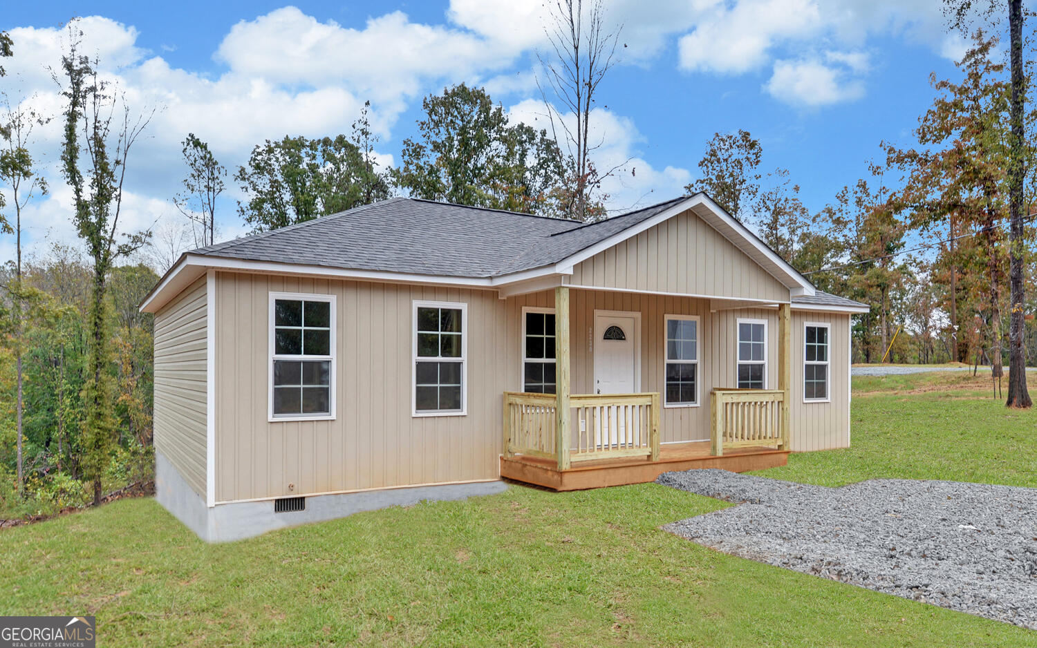 a view of a house with a yard and tree s