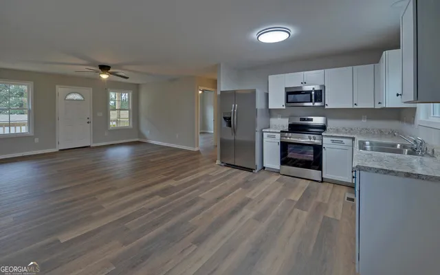 a view of kitchen with sink microwave and stove