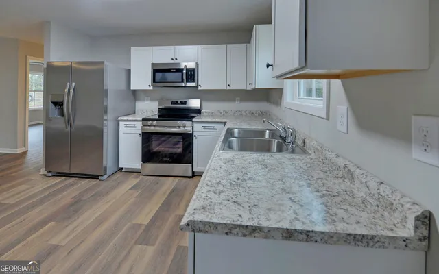 a kitchen with granite countertop a stove and a refrigerator