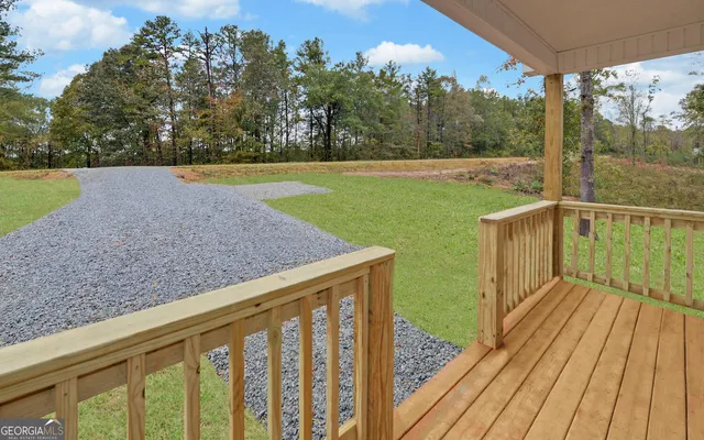 a view of a balcony with wooden floor and fence