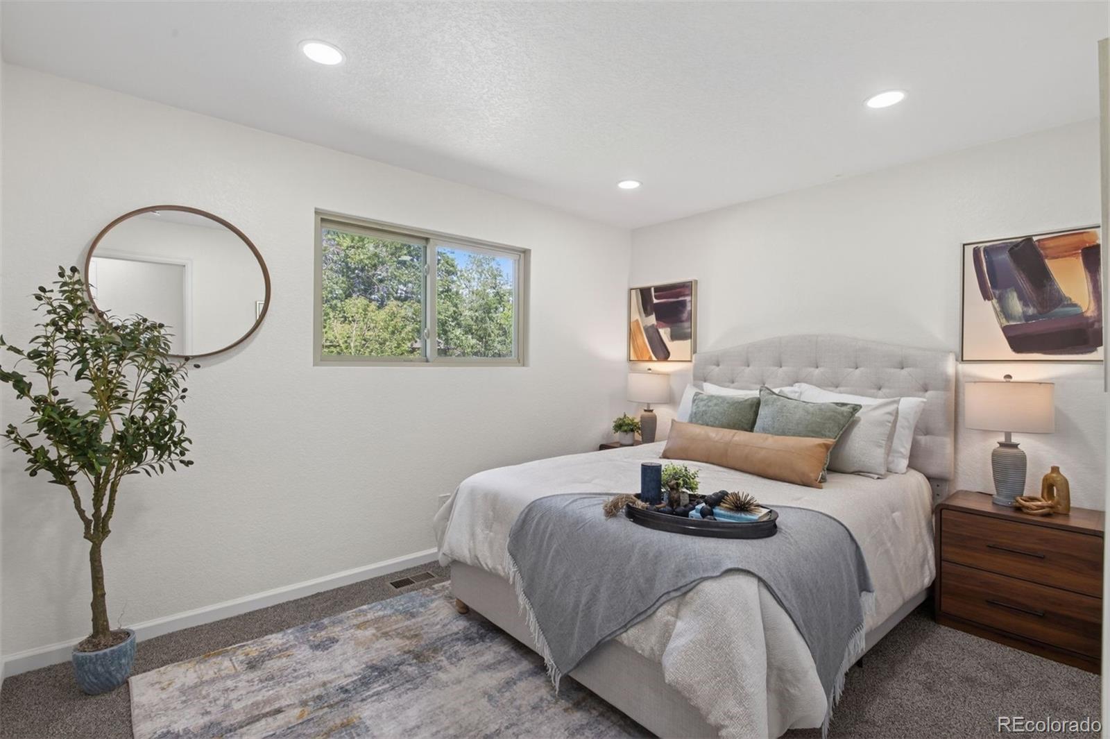 9079 Dudley Street Westminster, CO 80021 - Photo 12 of 37 a bedroom with a bed and a potted plant