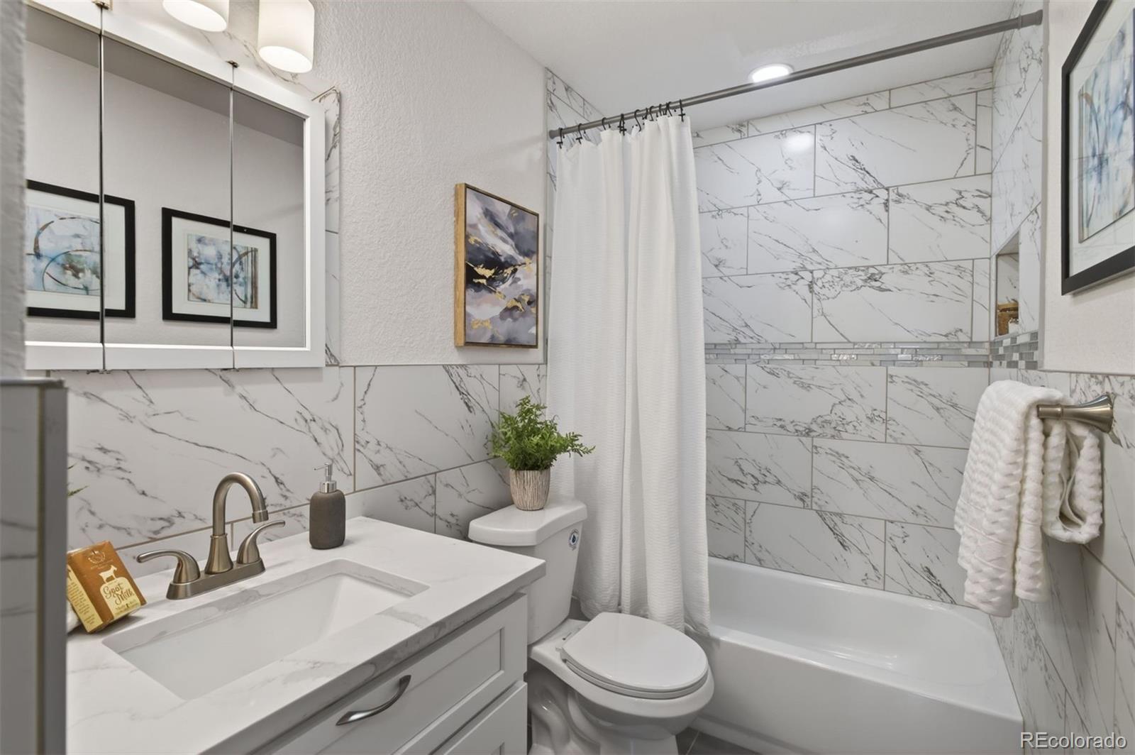 9079 Dudley Street Westminster, CO 80021 - Photo 13 of 37 a bathroom with a sink toilet and shower