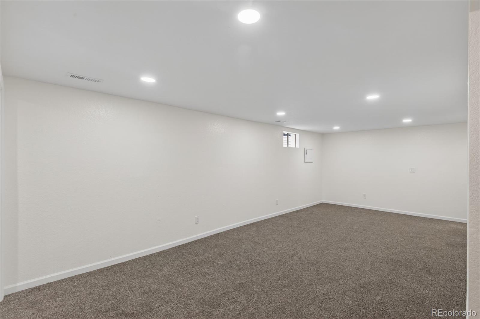 9079 Dudley Street Westminster, CO 80021 - Photo 20 of 37 an empty room with a empty space and window
