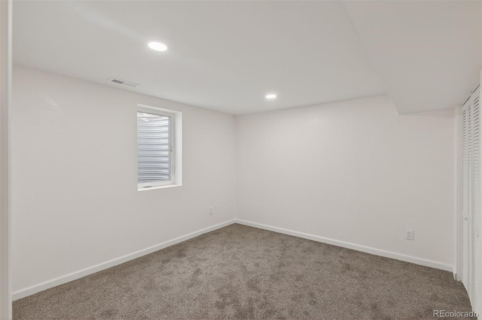 9079 Dudley Street Westminster, CO 80021 - Photo 22 of 37 an empty room with a window