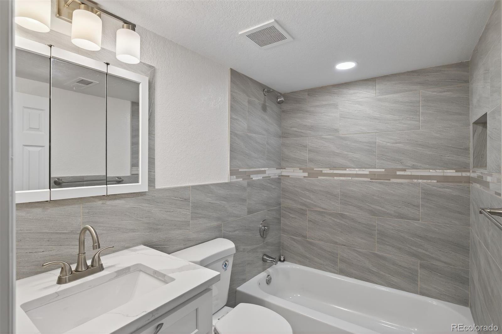 9079 Dudley Street Westminster, CO 80021 - Photo 23 of 37 a bathroom with a sink toilet and shower