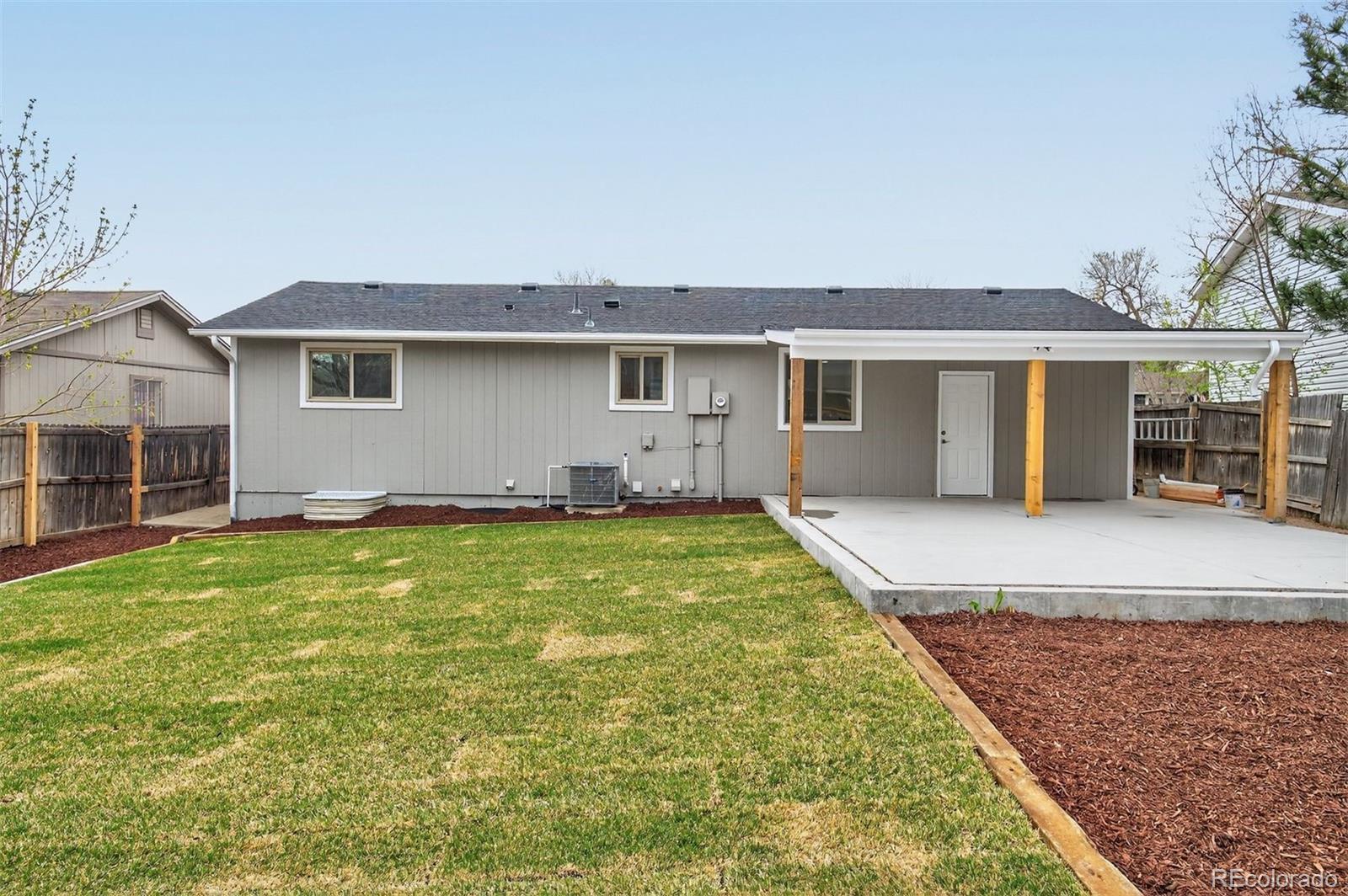 9079 Dudley Street Westminster, CO 80021 - Photo 28 of 37 a front view of house with yard