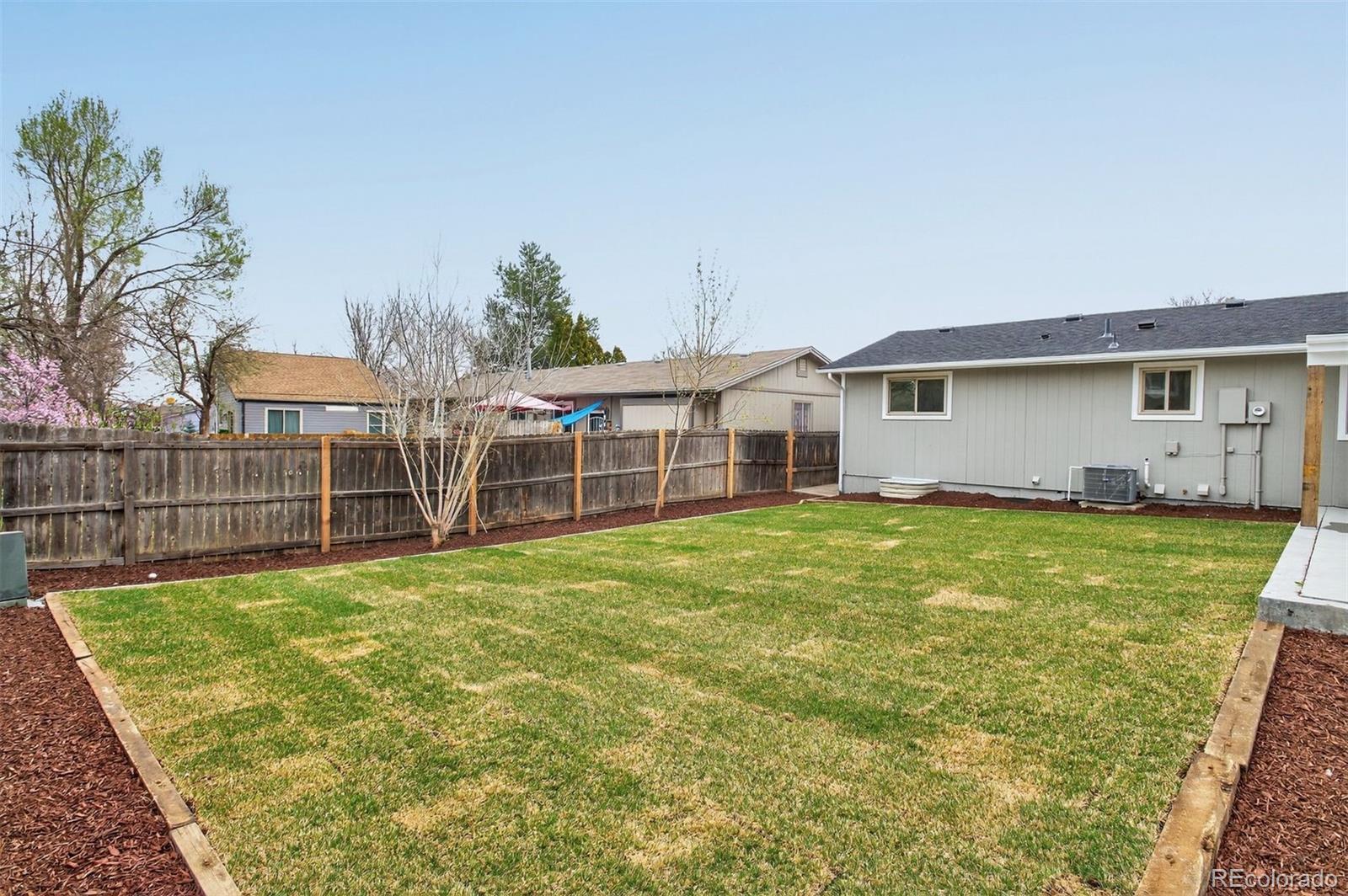 9079 Dudley Street Westminster, CO 80021 - Photo 34 of 37 a view of a house with a backyard