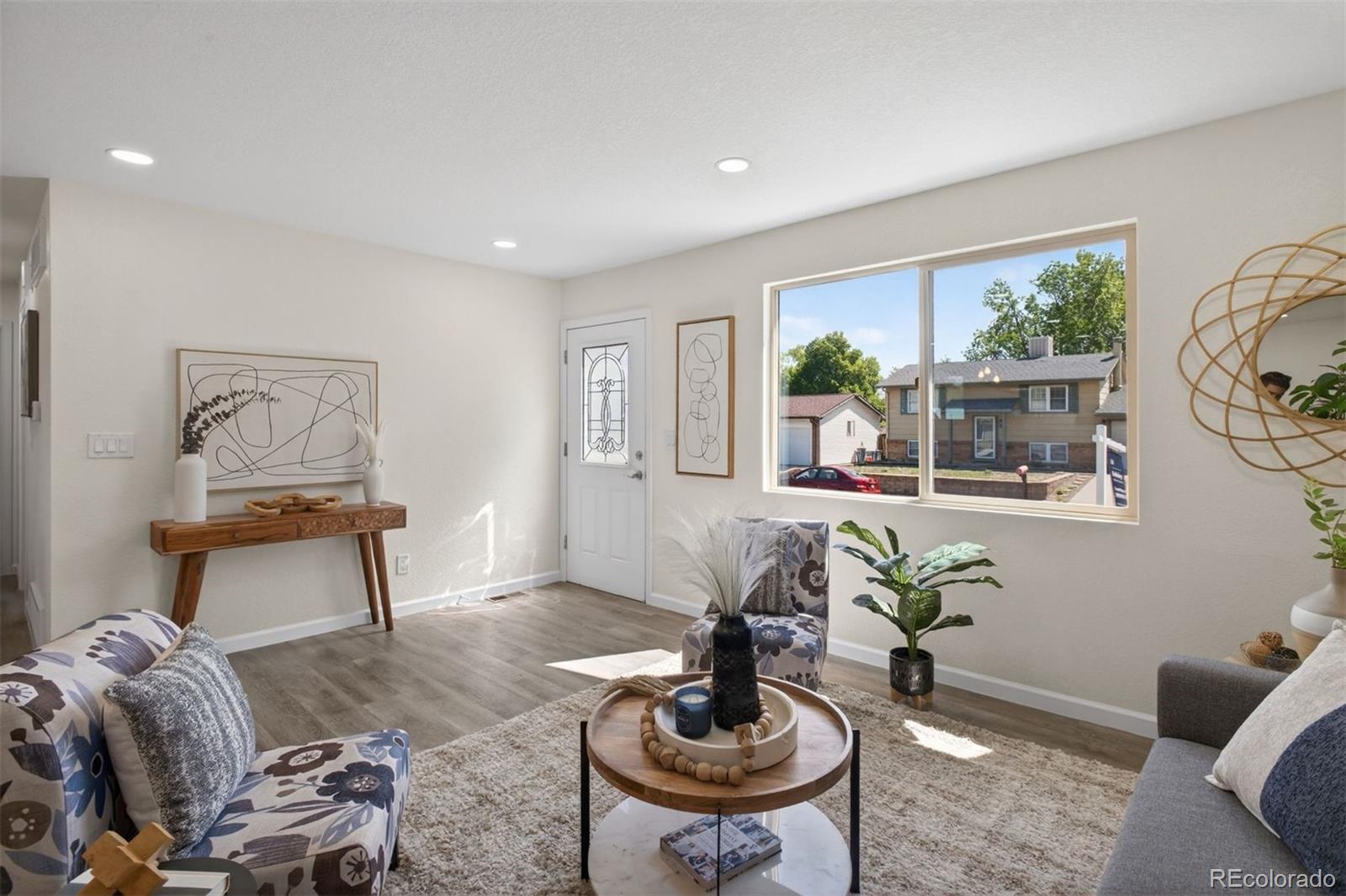 9079 Dudley Street Westminster, CO 80021 - Photo 5 of 37 a living room with furniture and a potted plant