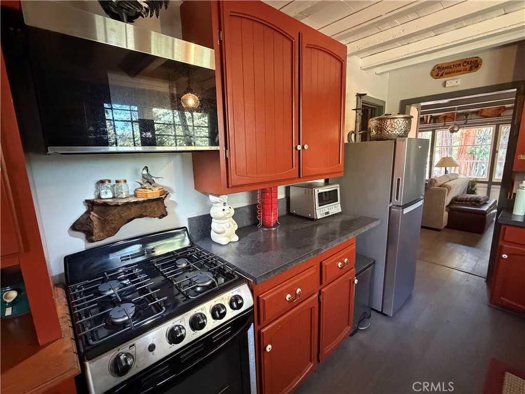 120 Barton Flats Road Angelus Oaks, CA 92305 - Photo 11 of 57 a kitchen with stainless steel appliances granite countertop a stove and a microwave