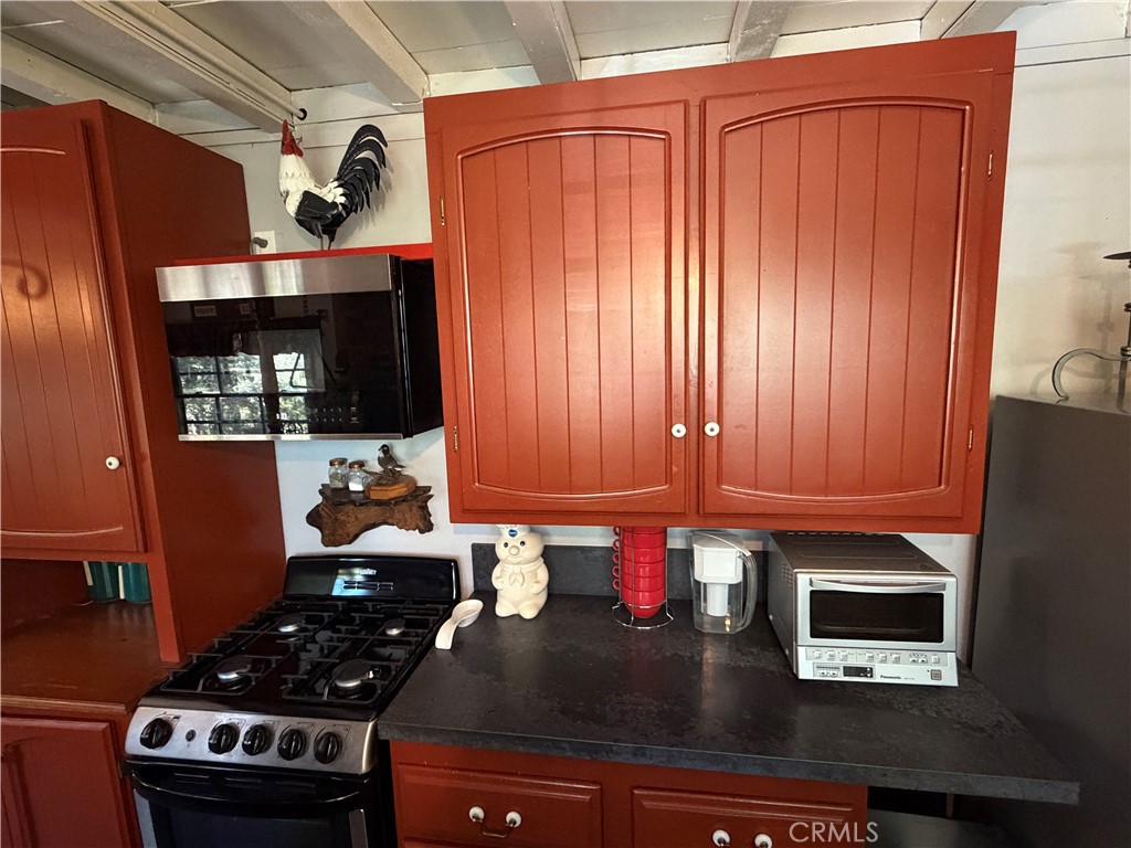 120 Barton Flats Road Angelus Oaks, CA 92305 - Photo 12 of 57 a kitchen with granite countertop stainless steel appliances a stove a sink and cabinets
