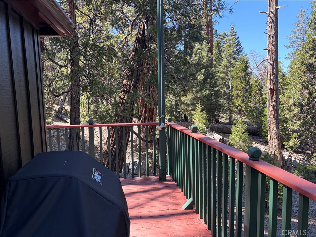 120 Barton Flats Road Angelus Oaks, CA 92305 - Photo 25 of 57 a balcony with wooden floor and trees in the back