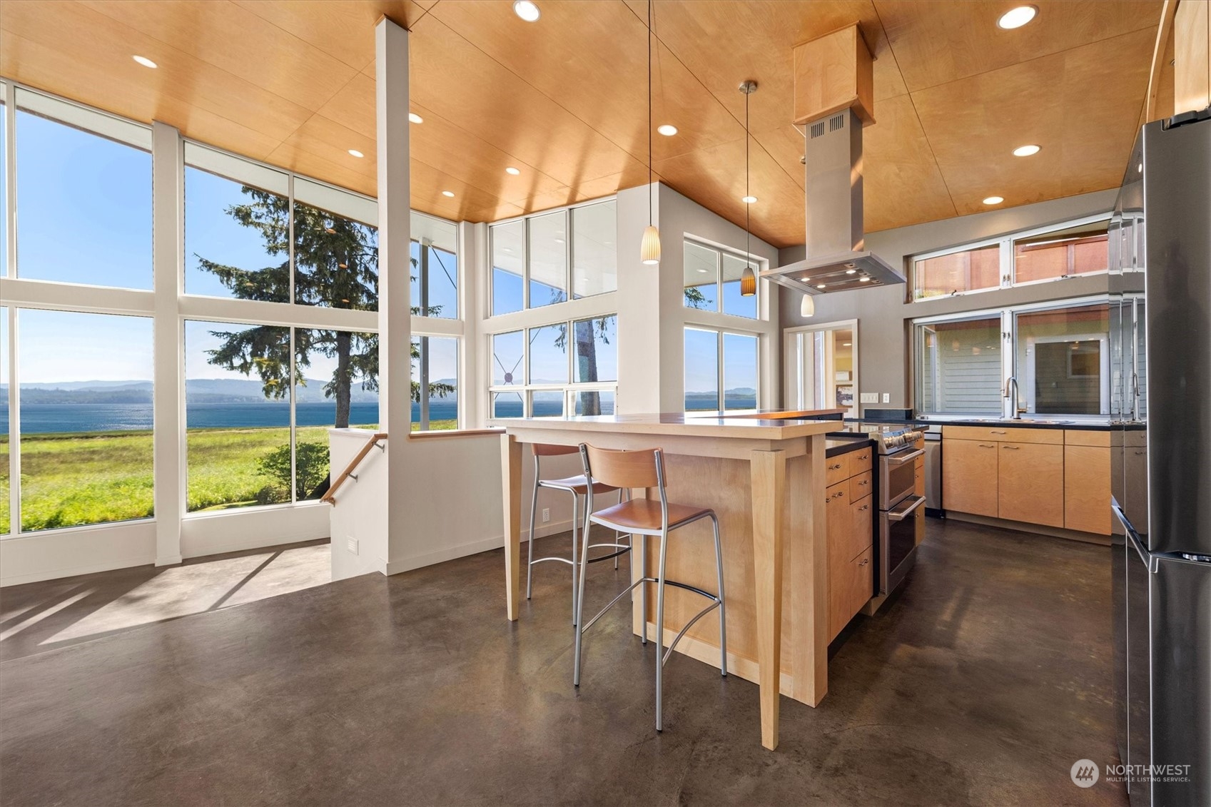15550 Sandridge Road Long Beach, WA 98631 - Photo 9 of 36 a view of a kitchen with kitchen island stainless steel appliances wooden floor dining table and chairs