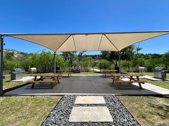 a view of a swimming pool with lounge chairs in patio