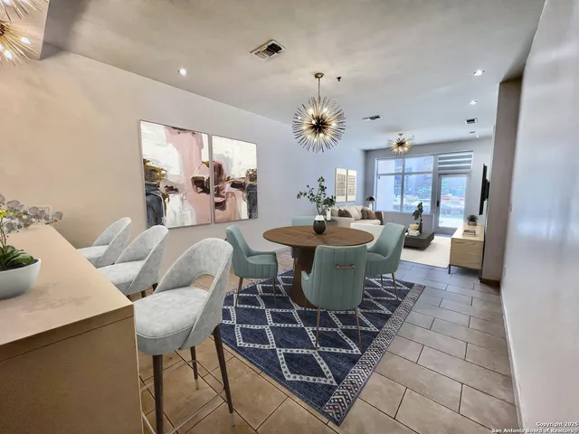 a dining room with furniture a rug and a chandelier