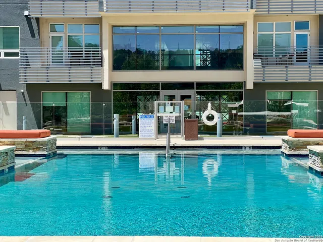 a view of swimming pool with outdoor seating