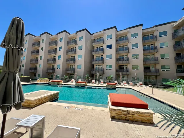 a view of building with yard and outdoor seating
