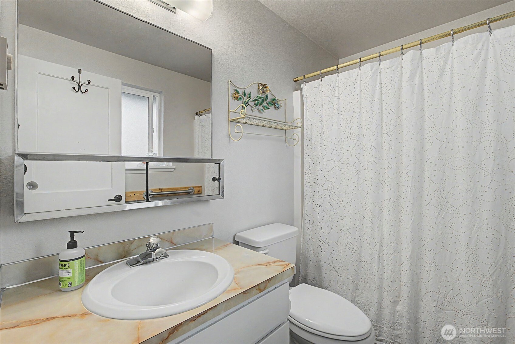 1611 Ham Hill Road Centralia, WA 98531 - Photo 14 of 40 a bathroom with a sink a toilet and shower curtain
