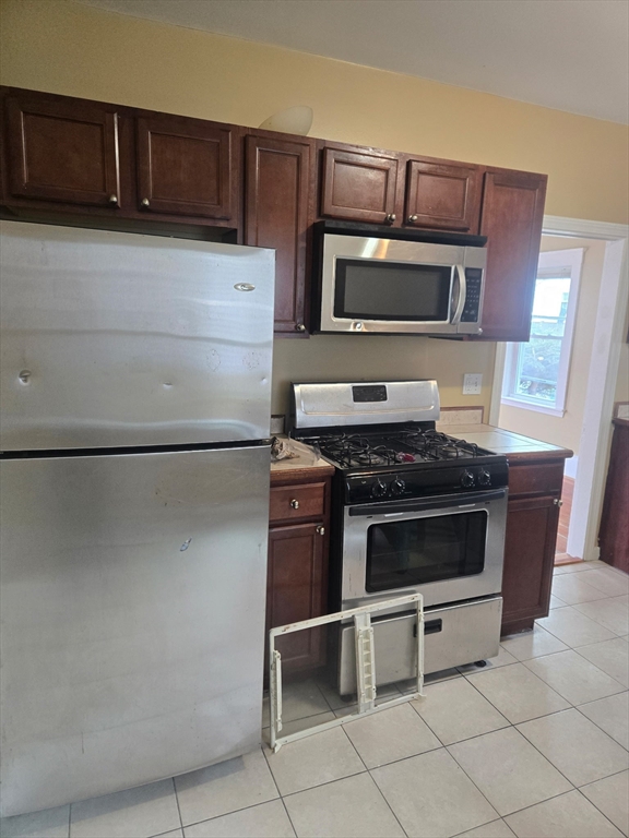 53 Groveland Street Lynn, MA 01902 - Photo 12 of 28 a kitchen with stainless steel appliances and cabinets