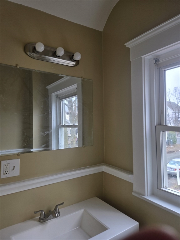53 Groveland Street Lynn, MA 01902 - Photo 18 of 28 a bathroom with a tub and a window