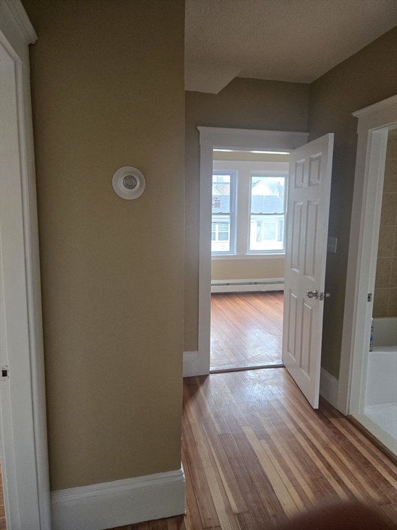 53 Groveland Street Lynn, MA 01902 - Photo 19 of 28 an empty room with wooden floor and windows