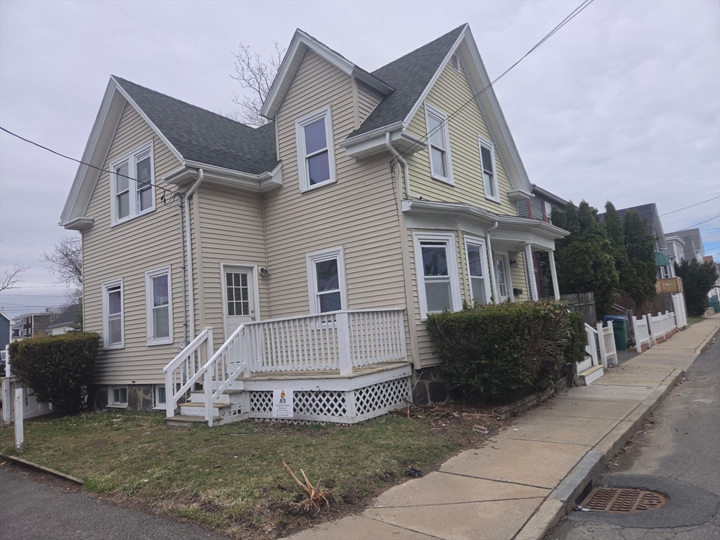 53 Groveland Street Lynn, MA 01902 - Photo 2 of 28 a front view of a house with a garden and plants