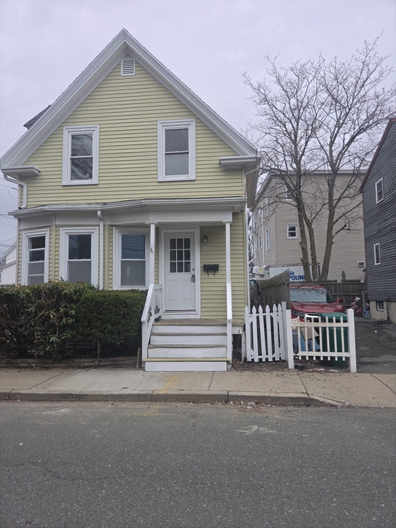 53 Groveland Street Lynn, MA 01902 - Photo 3 of 28 a front view of a house with a garden