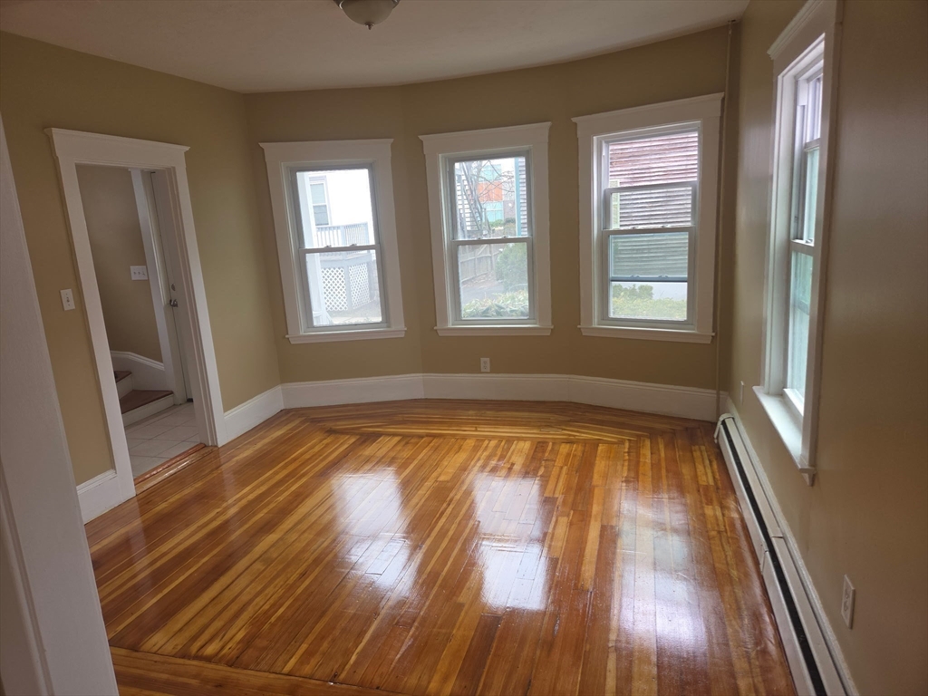 53 Groveland Street Lynn, MA 01902 - Photo 7 of 28 a view of empty room with wooden floor and fan