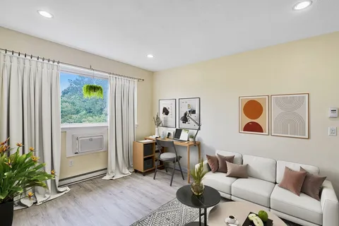 a living room with furniture and a window